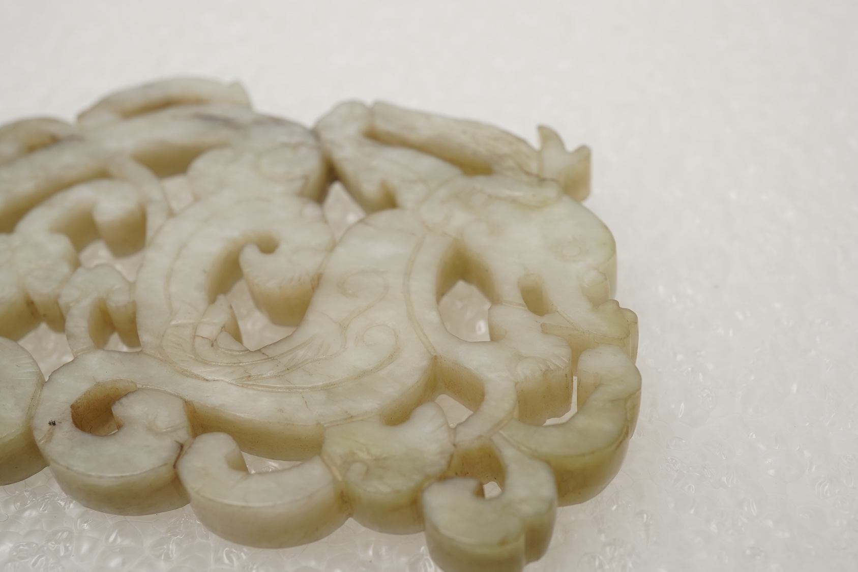 A Chinese white and grey mottled jade ‘chilong’ plaque, Ming dynasty